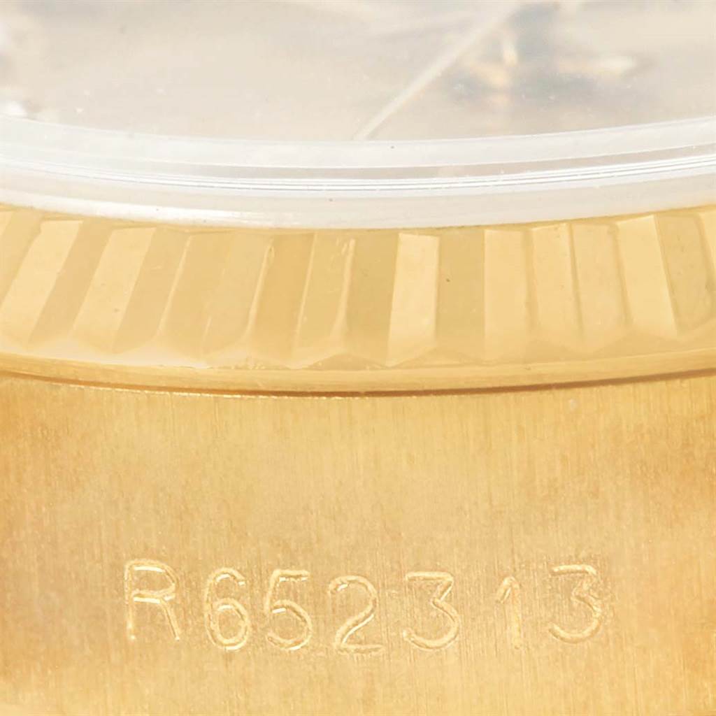 The image shows a close-up of the side of a Rolex President 69178 Women's Yellow Gold Champagne Dial 69178 Women's Yellow Gold Champagne Dial watch, highlighting the case and serial number.