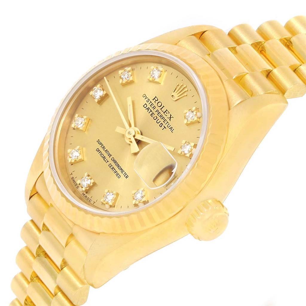 This is a close-up angle of a Rolex President 69178 Women's Yellow Gold Champagne Dial 69178 Women's Yellow Gold Champagne Dial model watch showing the dial, crown, and part of the bracelet.