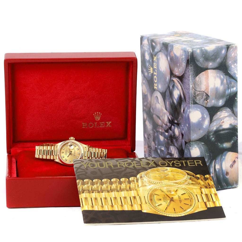 The image shows a Rolex President 69178 Women's Yellow Gold Champagne Dial 69178 Women's Yellow Gold Champagne Dial model watch in a red Rolex box, alongside its packaging and manual.