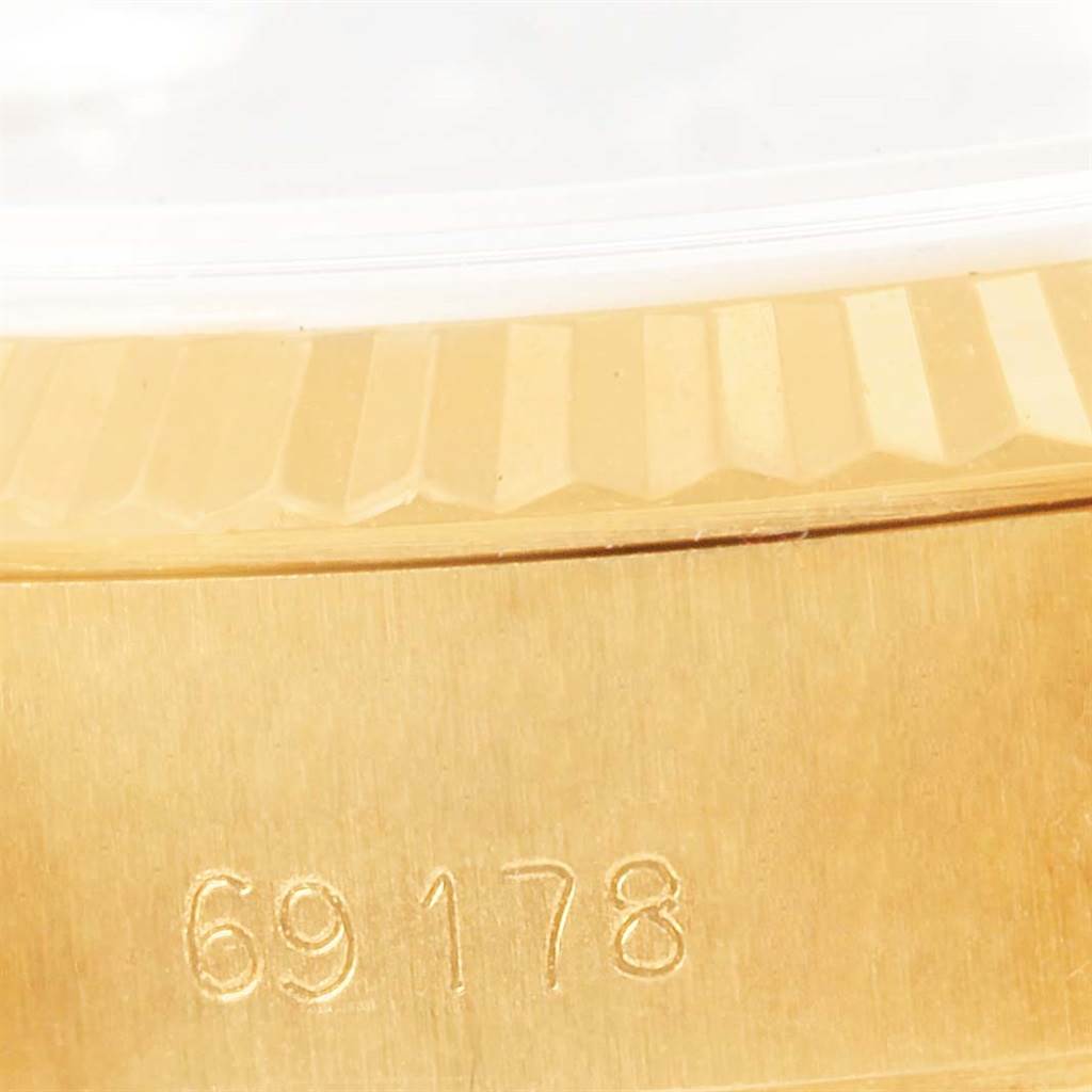 The image shows a close-up of the side view of a Rolex President 69178 Women's Yellow Gold Champagne Dial 69178 Women's Yellow Gold Champagne Dial watch model, specifically highlighting the serial number.