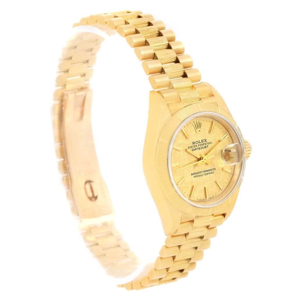 The photo shows a side angle of a Rolex President 69278 Women's Yellow Gold Champagne Dial 69278 Women's Yellow Gold Champagne Dial model watch, highlighting the gold band, case, and face.