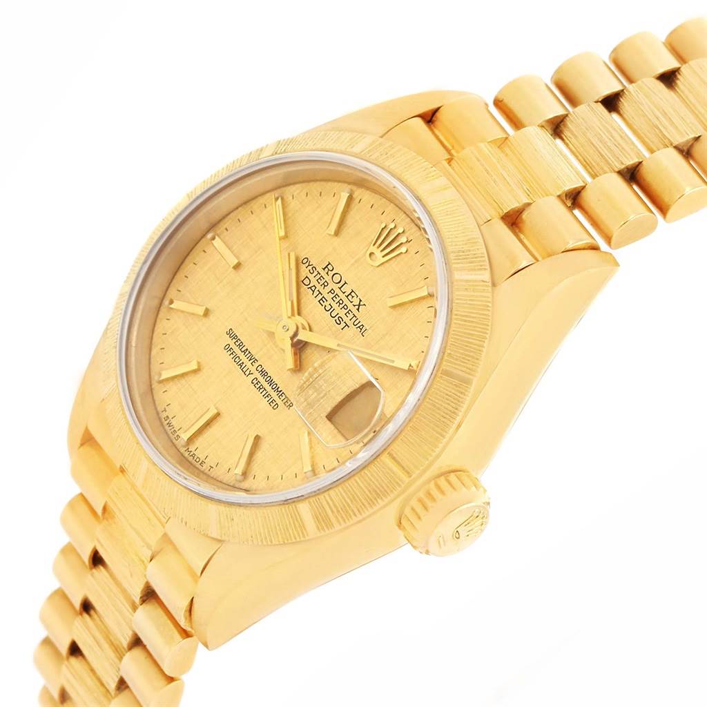 The image shows a side angle of a Rolex President 69278 Women's Yellow Gold Champagne Dial 69278 Women's Yellow Gold Champagne Dial model watch, highlighting the face, crown, and part of the band.