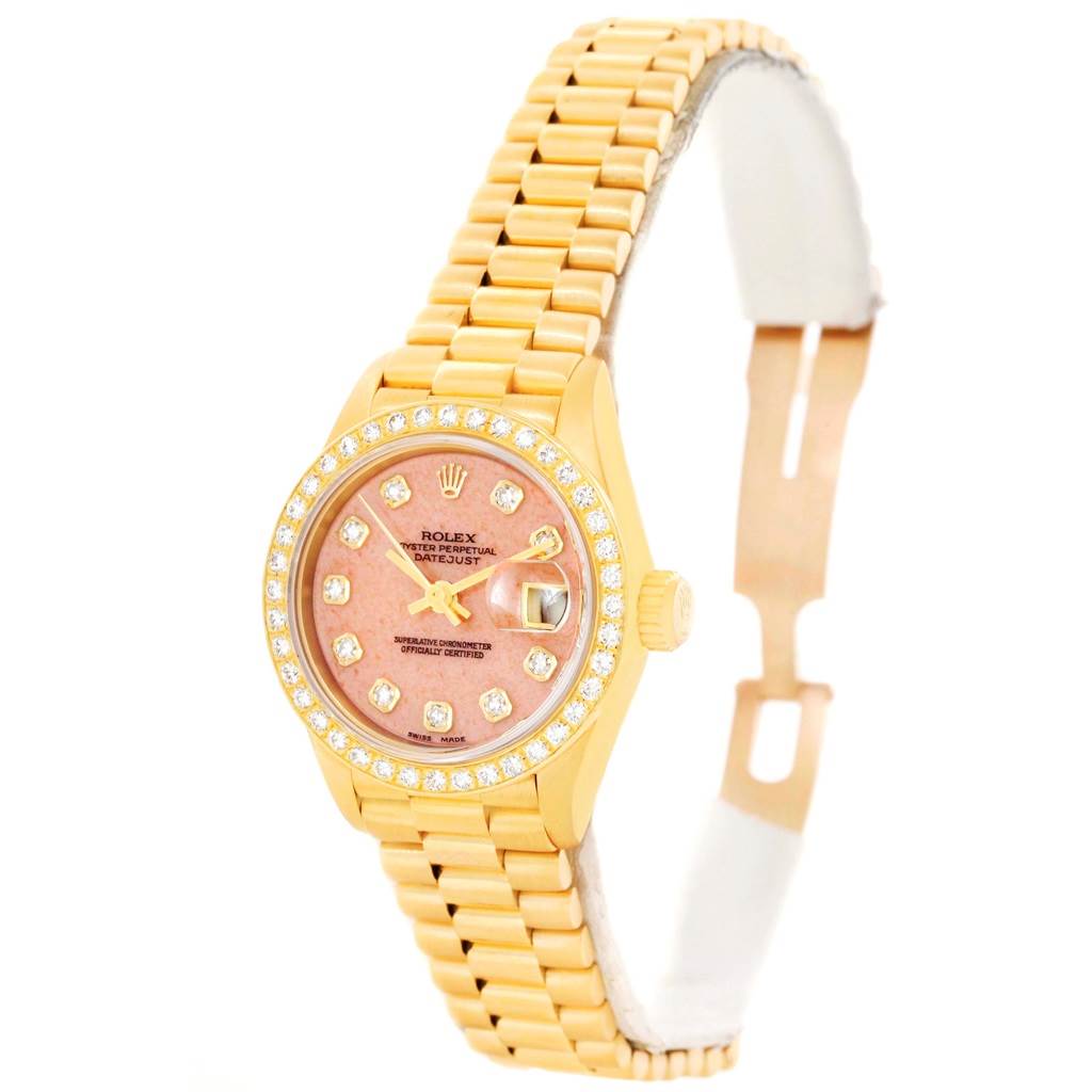 The image shows a Rolex President 69138 Women's Yellow Gold Pink Dial 69138 Women's Yellow Gold Pink Dial model watch at a slight angle, displaying its face, bezel with diamonds, and gold bracelet.