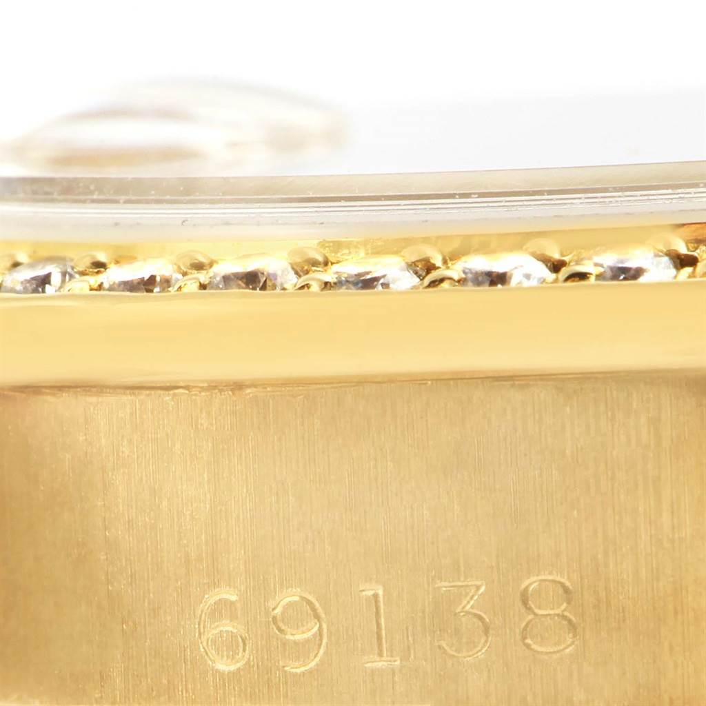 The image shows a close-up of the side of a Rolex President 69138 Women's Yellow Gold Pink Dial 69138 Women's Yellow Gold Pink Dial model watch, highlighting the bezel with diamonds and the model number 69138.