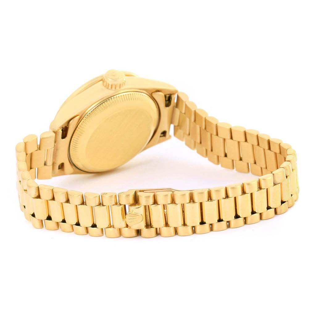 This image shows the backside and bracelet of a Rolex President 69138 Women's Yellow Gold Pink Dial 69138 Women's Yellow Gold Pink Dial model watch, highlighting its gold finish and clasp.