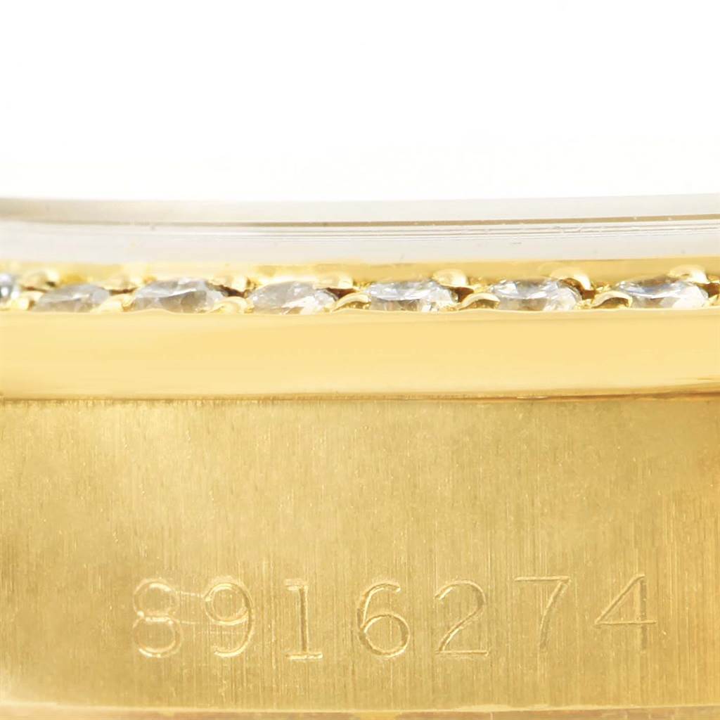 This close-up image shows the serial number and diamond-studded bezel of a Rolex President 69138 Women's Yellow Gold Pink Dial 69138 Women's Yellow Gold Pink Dial model watch.