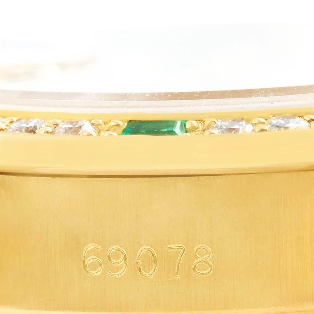 This image shows a close-up of the gold bezel, part of the crystal, and the model number 69078 of a Rolex President 69078 Women's Yellow Gold Silver Dial 69078 Women's Yellow Gold Silver Dial watch.