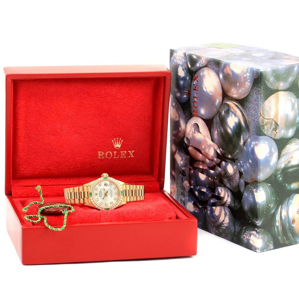 The Rolex President 69078 Women's Yellow Gold Silver Dial 69078 Women's Yellow Gold Silver Dial model watch is shown in an open red box with its original decorative outer packaging visible.