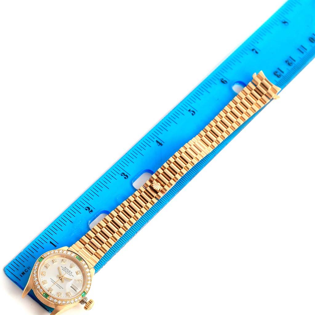 The image shows a Rolex President 69078 Women's Yellow Gold Silver Dial 69078 Women's Yellow Gold Silver Dial model watch from an overhead angle, with the face and entire band displayed alongside a blue ruler.