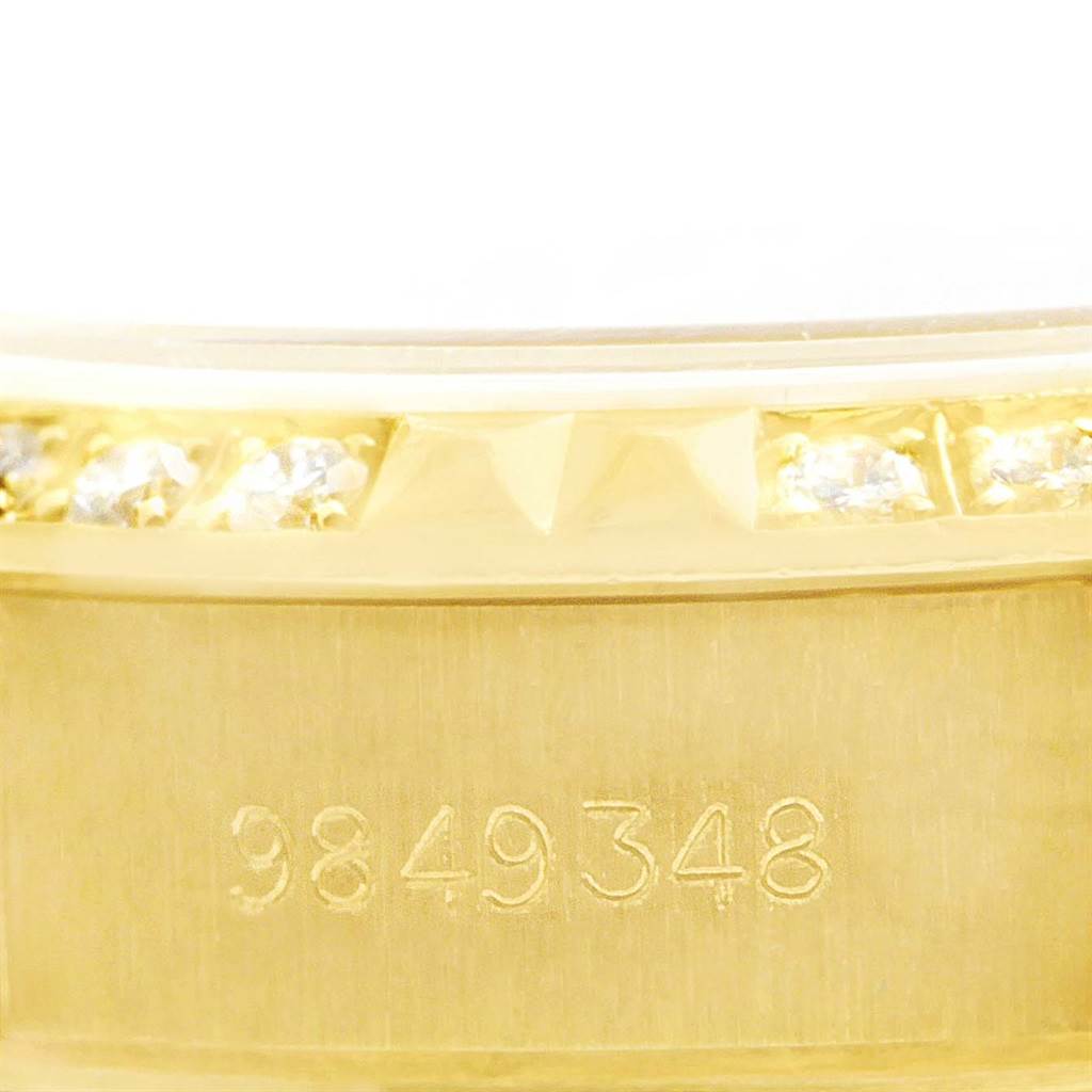 This close-up image shows the serial number and diamond-studded bezel of a Rolex President 69158 Women's Yellow Gold Champagne Dial 69158 Women's Yellow Gold Champagne Dial Model watch.