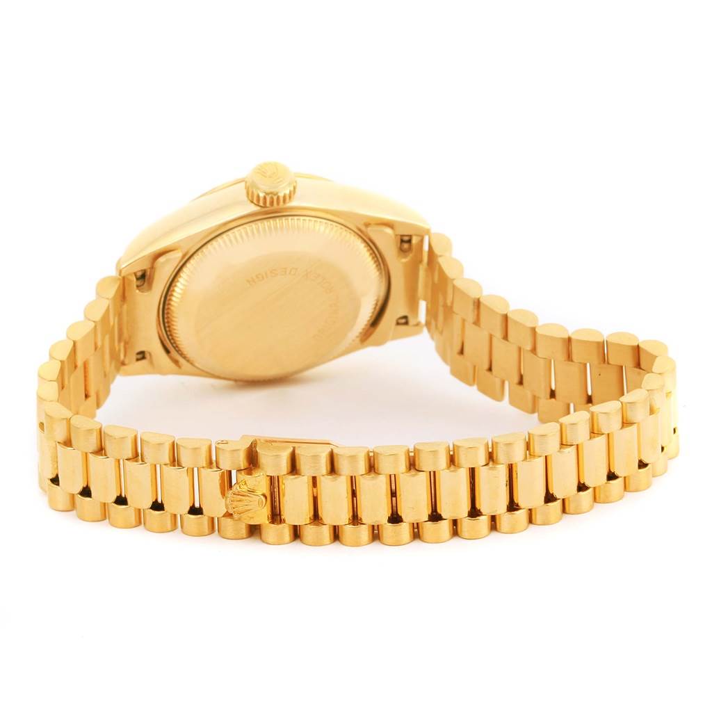 Shown from the rear, the Rolex President 69178 Women's Yellow Gold Champagne Dial 69178 Women's Yellow Gold Champagne Dial model displays its back case, crown, and gold bracelet.