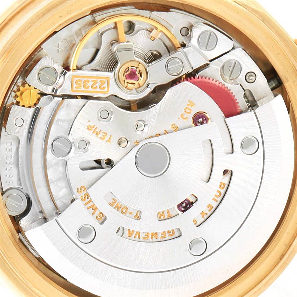 This is an internal view of the Rolex President 79288 Women's Yellow Gold Red Dial 79288 Women's Yellow Gold Red Dial model watch, showing its intricate mechanical movement and components.