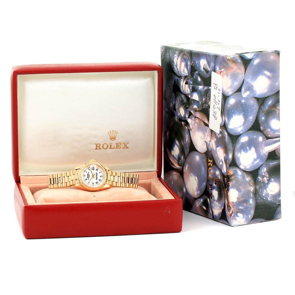 The Rolex President 69178 Women's Yellow Gold White Dial 69178 Women's Yellow Gold White Dial model watch is shown in its open red case, with the closed branded outer box beside it.