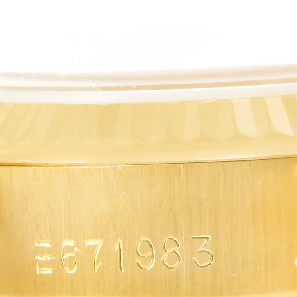 This close-up image shows the side of a Rolex President 69178 Women's Yellow Gold White Dial 69178 Women's Yellow Gold White Dial model with engraved serial number E671983.