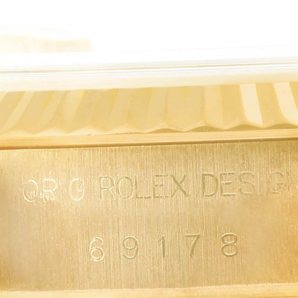 This image shows a close-up of the side engraving on the case of a Rolex President 69178 Women's Yellow Gold Champagne Dial 69178 Women's Yellow Gold Champagne Dial model watch.
