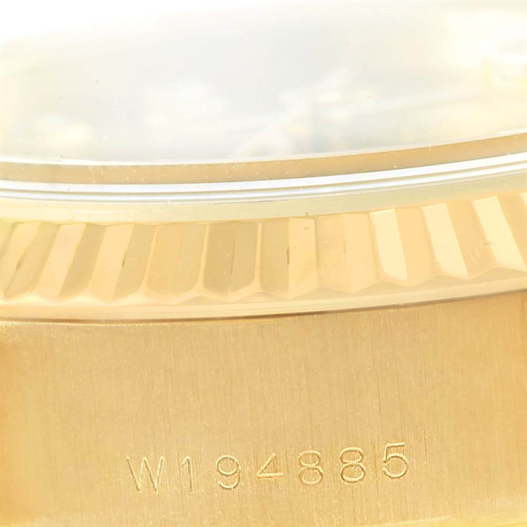 The image shows a close-up angle of the serial number and fluted bezel of a Rolex President 69178 Women's Yellow Gold Champagne Dial 69178 Women's Yellow Gold Champagne Dial model watch.