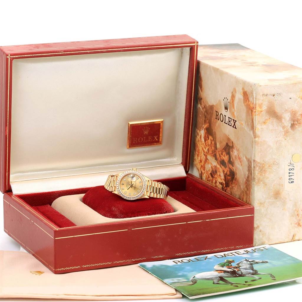 The image shows a Rolex President 69178 Women's Yellow Gold Champagne Dial 69178 Women's Yellow Gold Champagne Dial model watch in its open display box, along with an outer box, cloth, and a booklet.