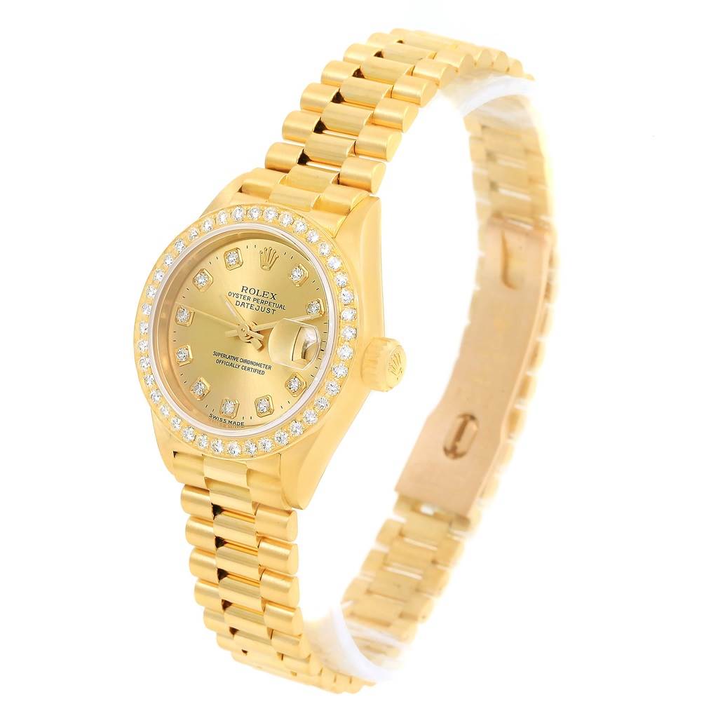 This image shows a Rolex President 69178 Women's Yellow Gold Champagne Dial 69178 Women's Yellow Gold Champagne Dial model watch from an oblique top angle highlighting the gold bracelet and diamond-studded bezel.
