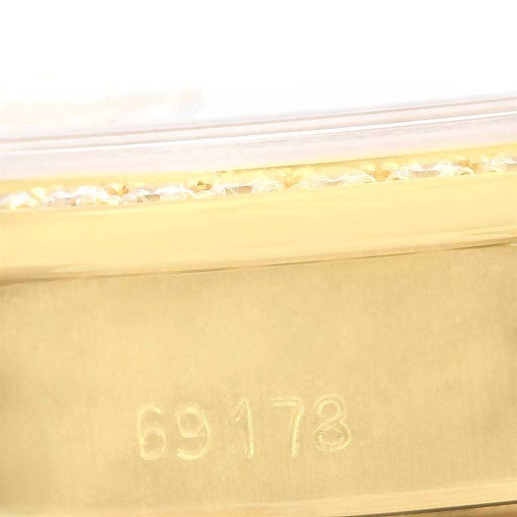 The image shows a close-up of the side of a Rolex President 69178 Women's Yellow Gold Champagne Dial 69178 Women's Yellow Gold Champagne Dial model watch, focusing on the bracelet's serial number engraving.