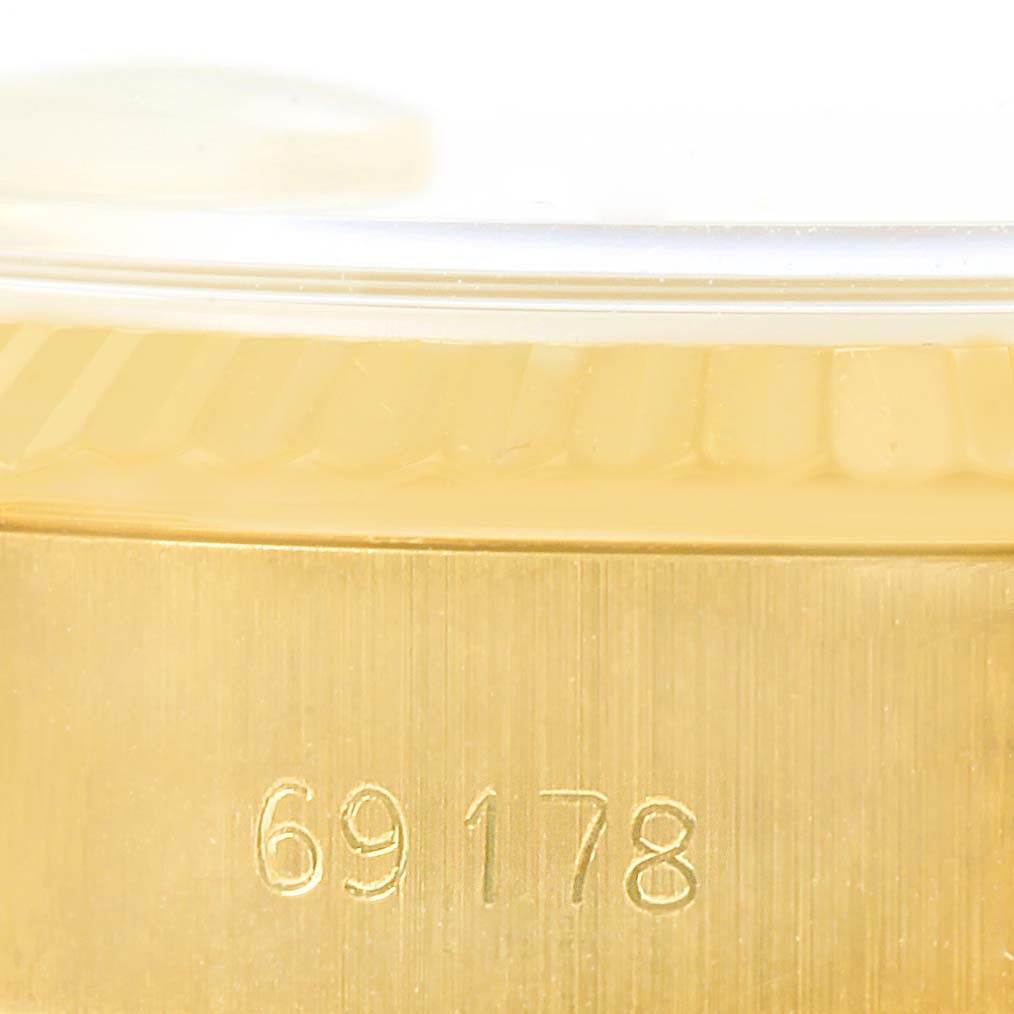 The image shows a close-up of the side of a Rolex President 69178 Women
s Yellow Gold Champagne Dial 69178 Women
s Yellow Gold Champagne Dial model watch, highlighting its engraved model number, 69178.