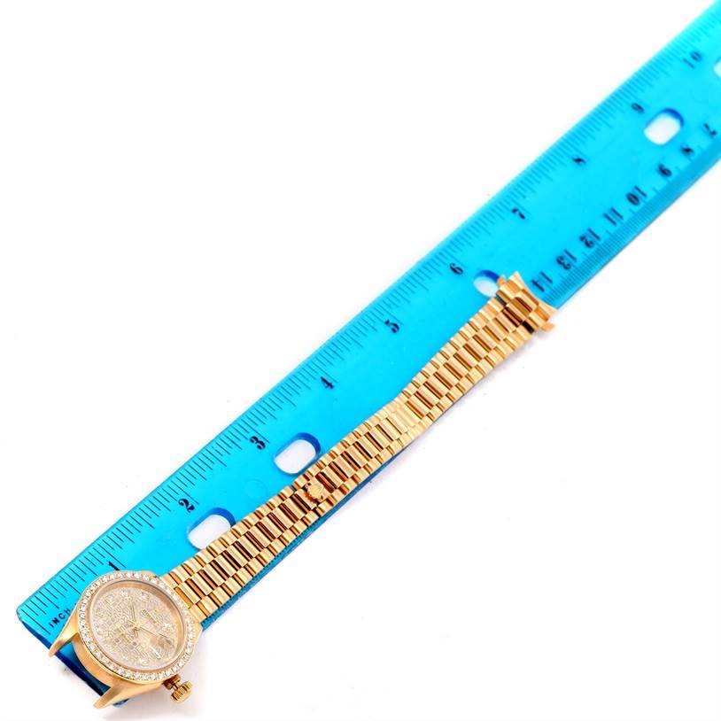 The image shows a Rolex President 79178 Women's Yellow Gold Silver Dial 79178 Women's Yellow Gold Silver Dial model watch lying flat, next to a ruler, displaying the face and the full length of the band.