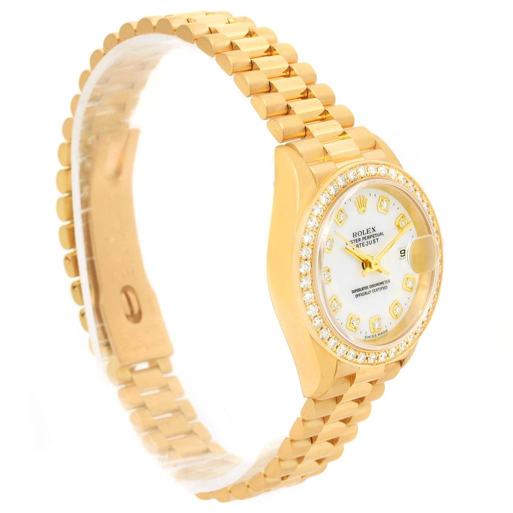 The image shows a side view of a Rolex President 69138 Women
s Yellow Gold White Dial 69138 Women
s Yellow Gold White Dial model watch, highlighting its gold bracelet, diamond bezel, and white dial.