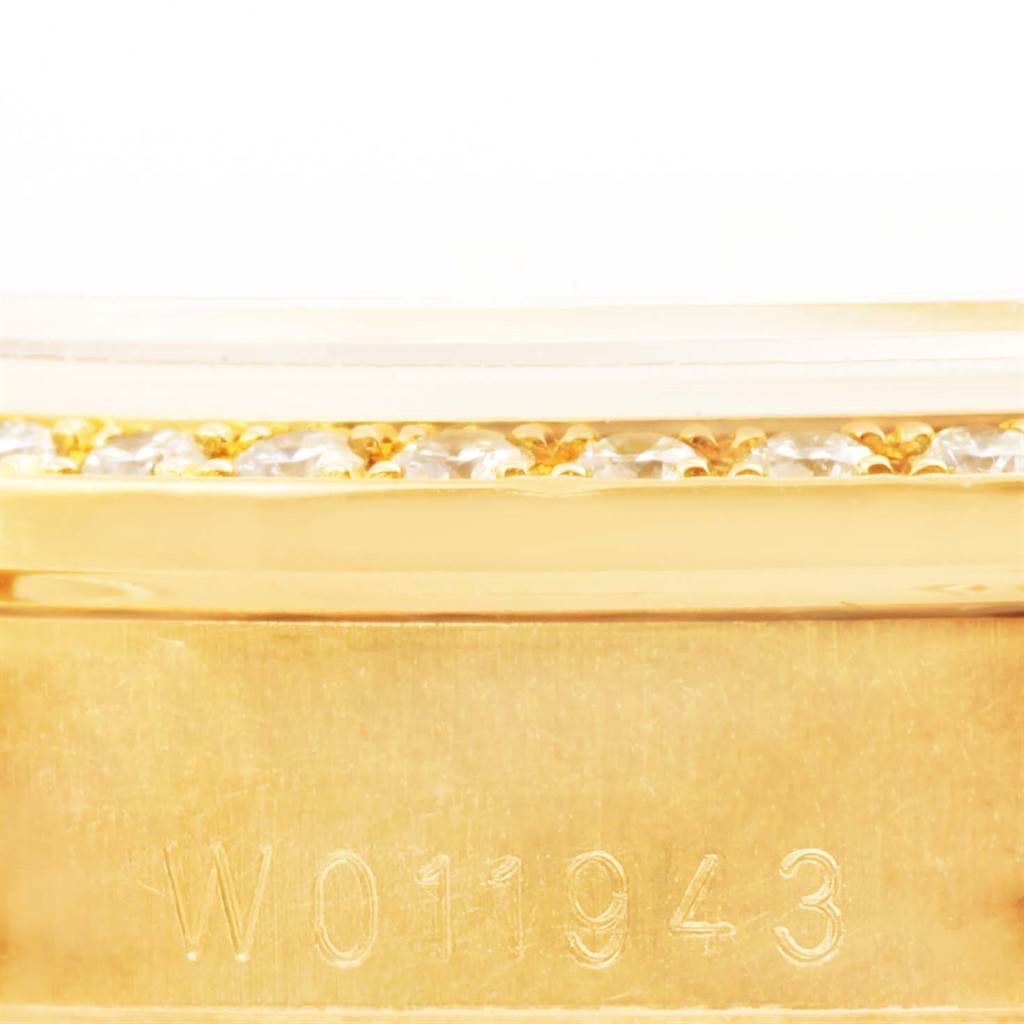 This close-up image shows the serial number engraved on the gold case, bezel, and diamond details of the Rolex President 68158 Women's Yellow Gold Champagne Dial 68158 Women's Yellow Gold Champagne Dial model watch.