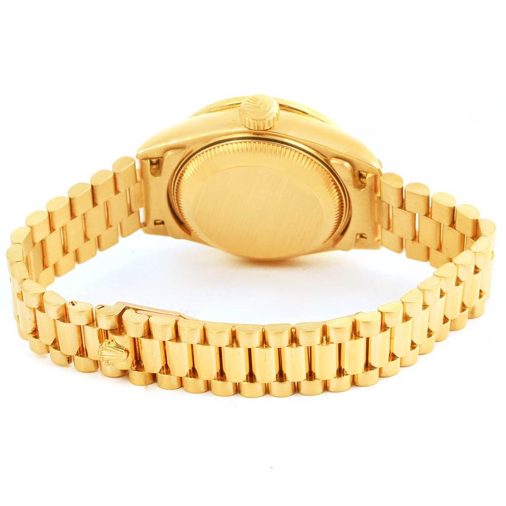 The image displays the back and bracelet of a Rolex President 69078 Women's Yellow Gold Champagne Dial 69078 Women's Yellow Gold Champagne Dial watch, highlighting the case back and gold links.