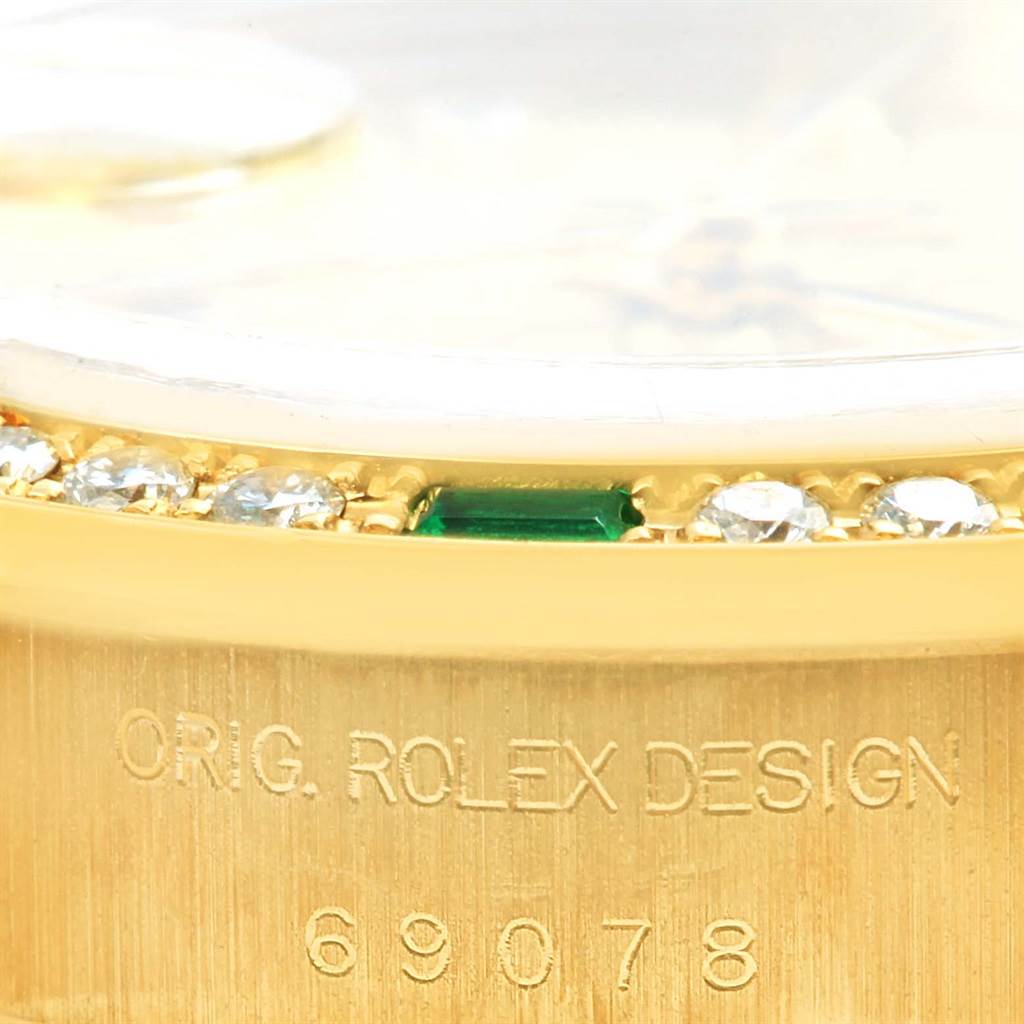 This close-up image shows the side view of a Rolex President 69078 Women's Yellow Gold Champagne Dial 69078 Women's Yellow Gold Champagne Dial model watch, highlighting the bezel with gems and engraved model number.