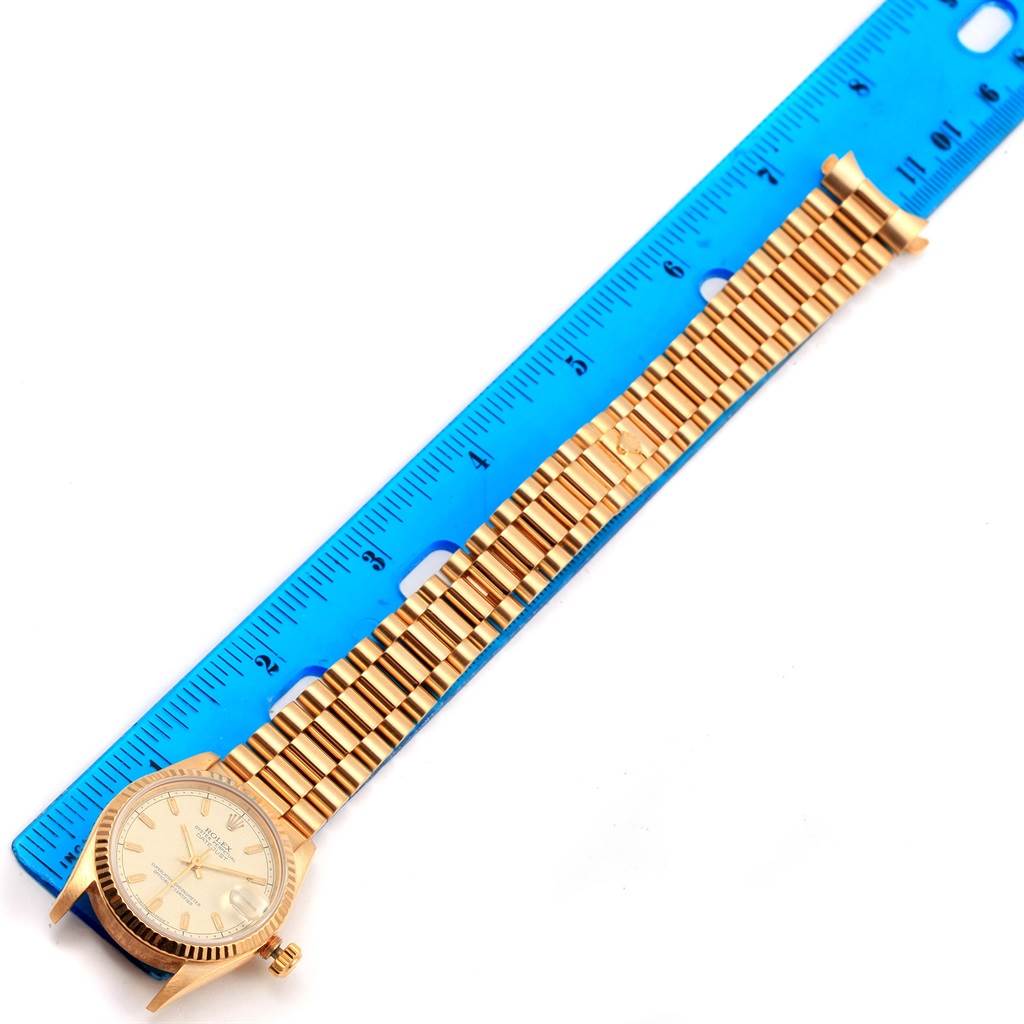 The Rolex President 68278 Women's Yellow Gold Beige Dial 68278 Women's Yellow Gold Beige Dial model watch is shown flat, with its dial, bracelet, and a blue measuring ruler.