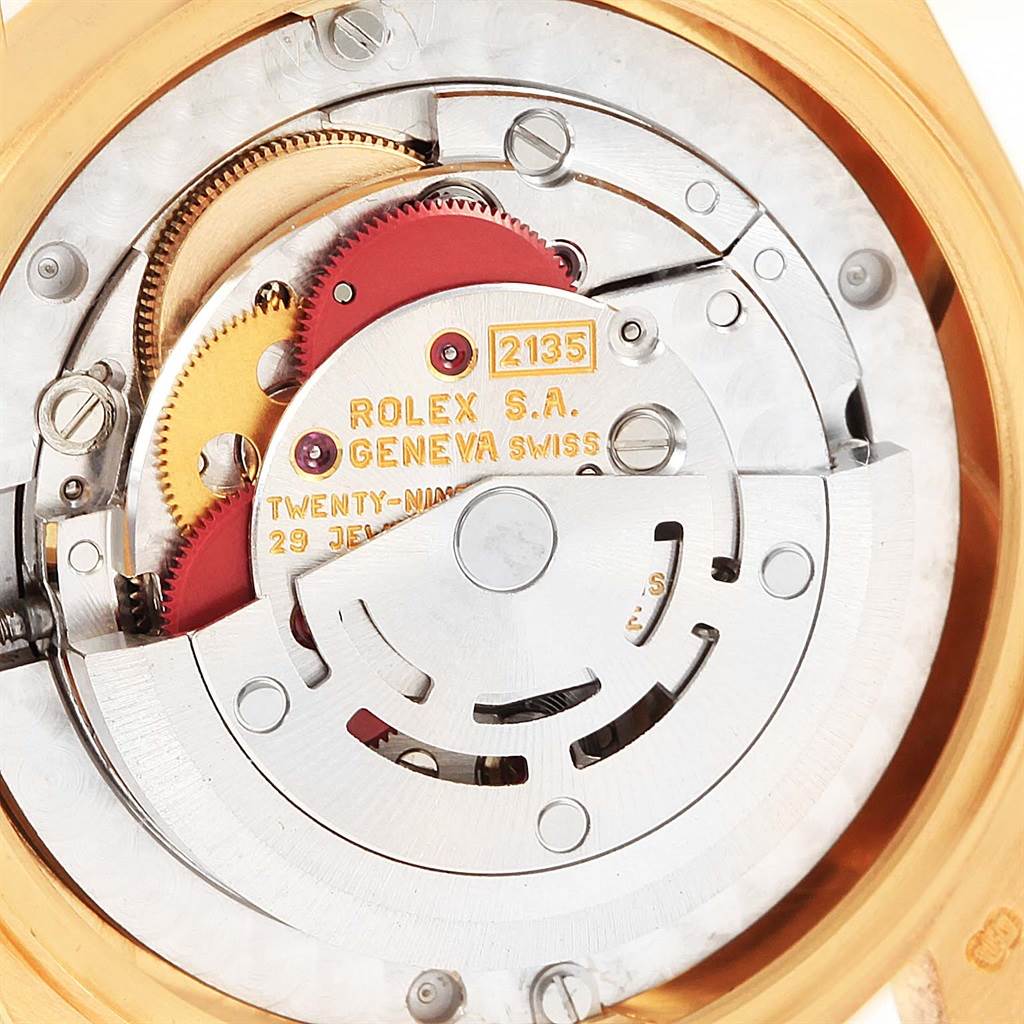 The image shows the inner mechanical movement of the Rolex President 68278 Women's Yellow Gold Beige Dial 68278 Women's Yellow Gold Beige Dial model, displaying intricate gears and components.
