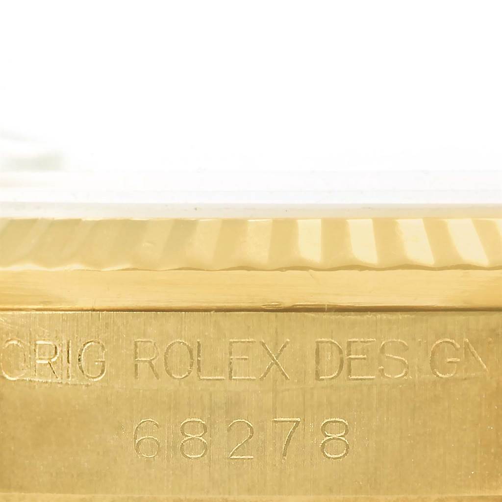 The image shows a close-up of the serial number engraved on the side of a Rolex President 68278 Women's Yellow Gold Beige Dial 68278 Women's Yellow Gold Beige Dial model watch case.
