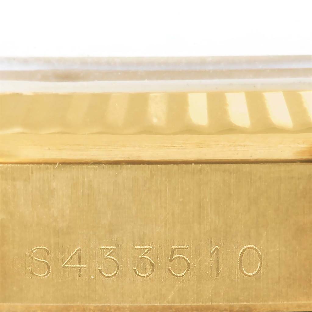 This close-up image shows the serial number engraved on the gold case of a Rolex President 68278 Women's Yellow Gold Beige Dial 68278 Women's Yellow Gold Beige Dial model.