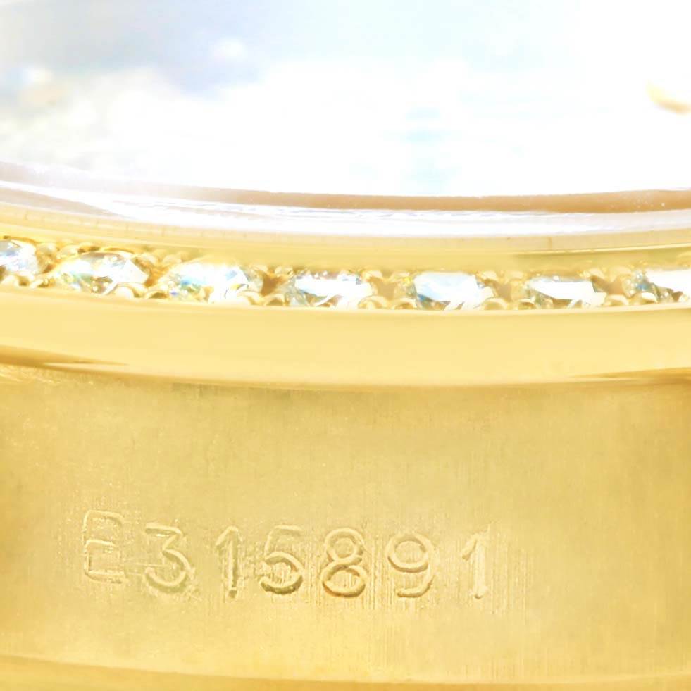 This image shows a close-up of the serial number and diamond-studded bezel of a Rolex President 69138 Women's Yellow Gold Champagne Dial 69138 Women's Yellow Gold Champagne Dial model watch.