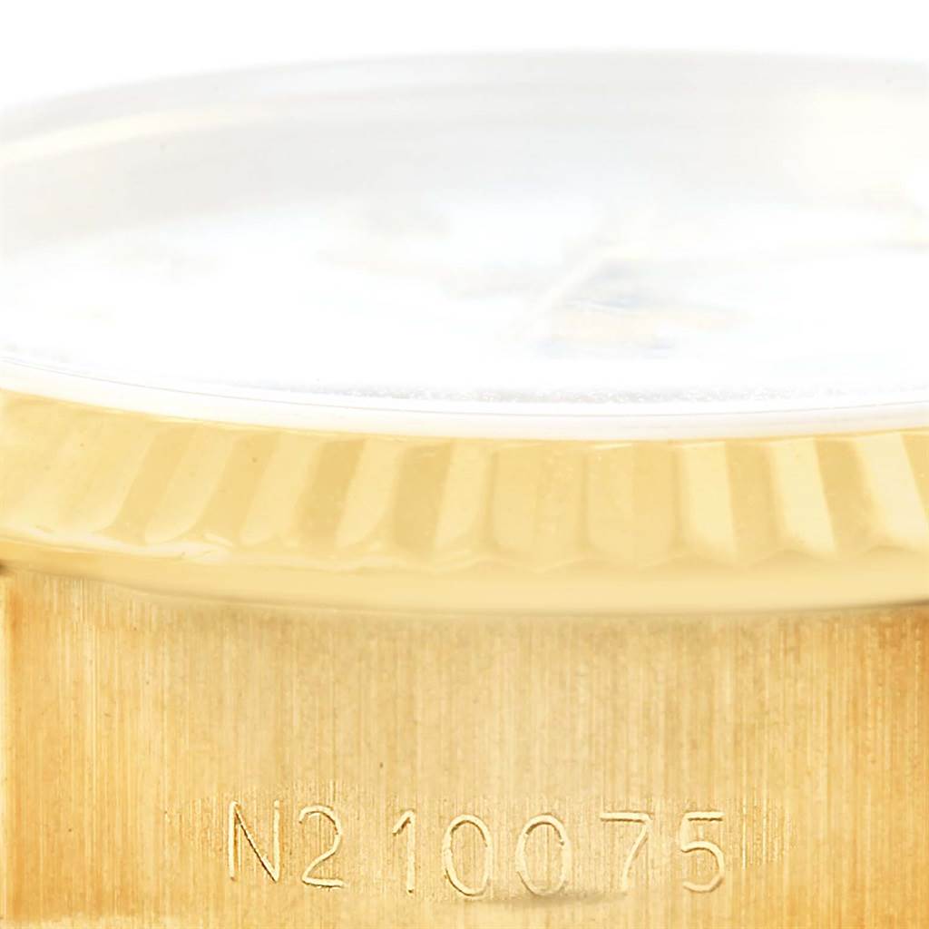 This close-up image shows the bezel and part of the case of a Rolex President 69178 Women's Yellow Gold White Dial 69178 Women's Yellow Gold White Dial watch.