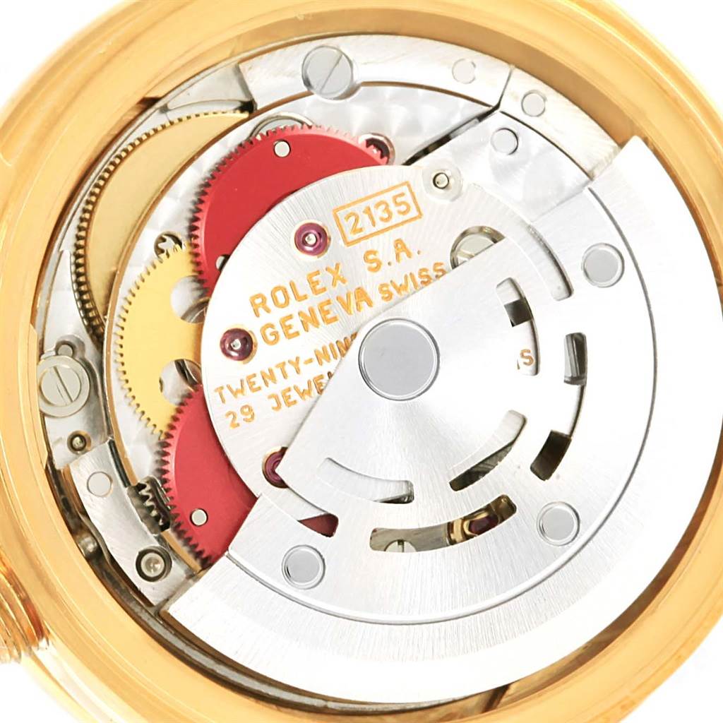 This is a close-up view of the Rolex President 69078 Women's Yellow Gold Champagne Dial 69078 Women's Yellow Gold Champagne Dial watch's movement, showcasing intricate gears and the rotor.