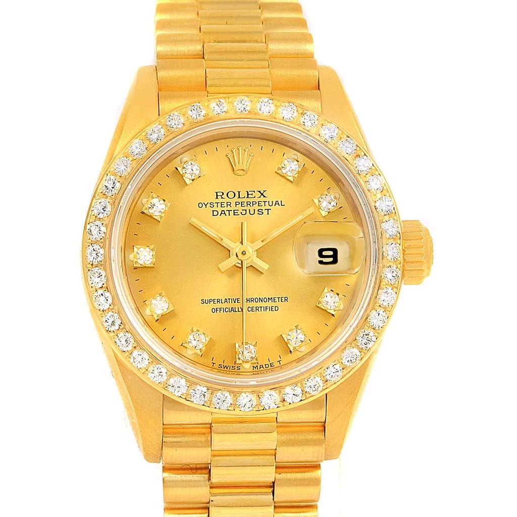 The Rolex President 69138 Women's Yellow Gold Champagne Dial 69138 Women's Yellow Gold Champagne Dial model watch is shown from a top-down angle, highlighting the face, bezel with diamonds, and part of the bracelet.