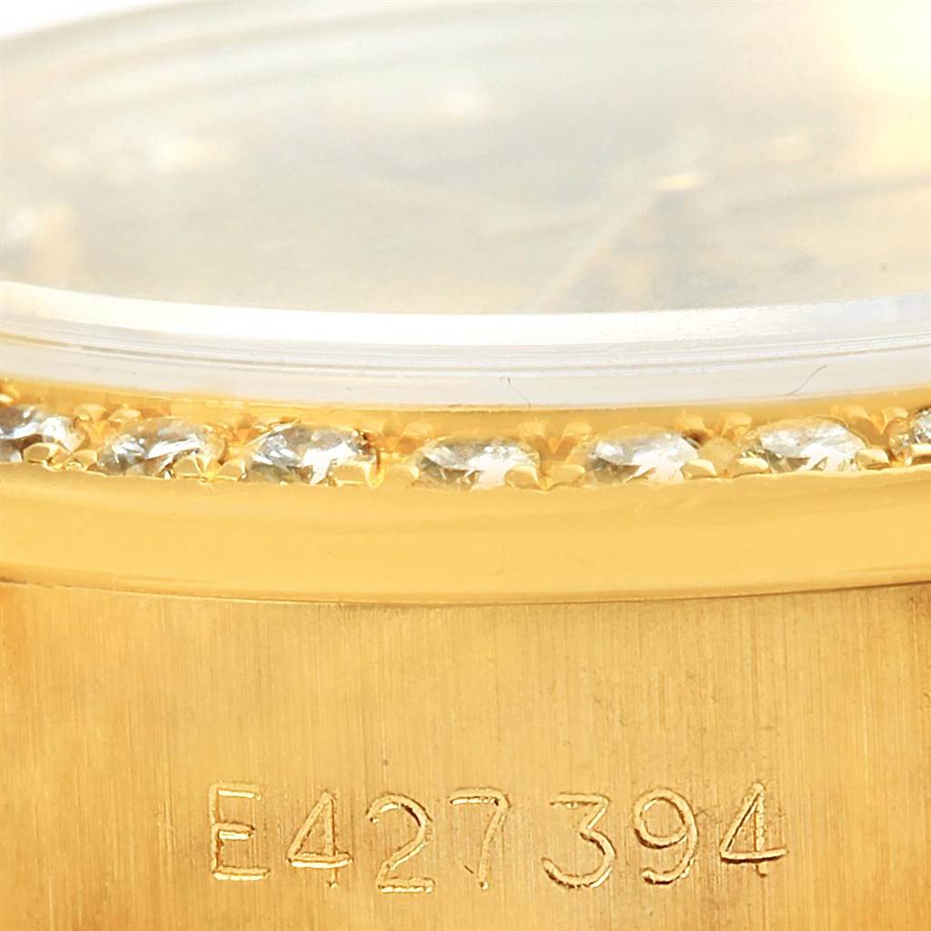 This close-up shows the bezel with diamonds and the engraved serial number on the gold case of the Rolex President 69138 Women's Yellow Gold Champagne Dial 69138 Women's Yellow Gold Champagne Dial model.