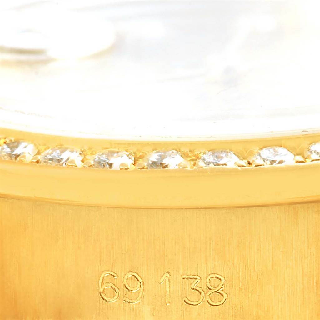 This image shows a close-up of the model number "69138" and part of the diamond-encrusted bezel on a Rolex President 69138 Women's Yellow Gold Champagne Dial 69138 Women's Yellow Gold Champagne Dial watch.