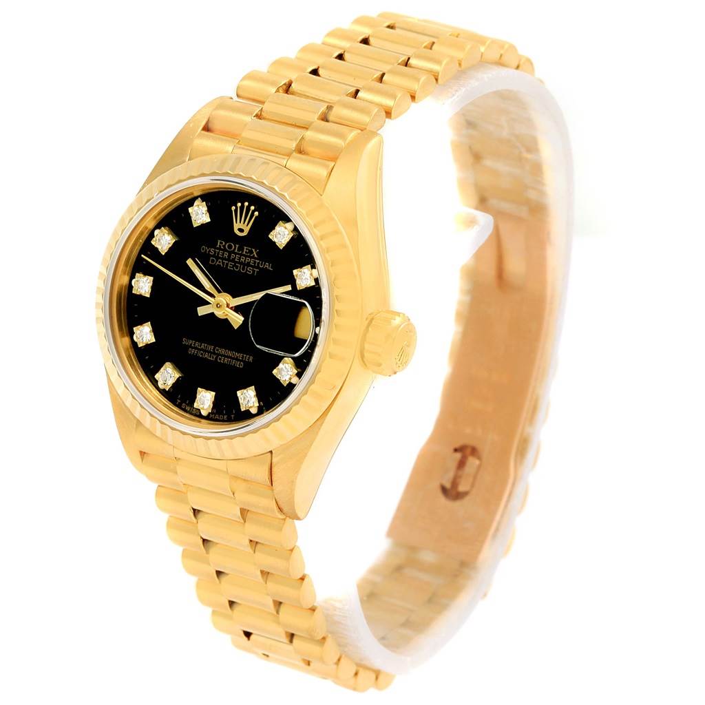 The image shows the President model by Rolex at a slight angle, highlighting the gold case, black dial, date window, and gold bracelet.