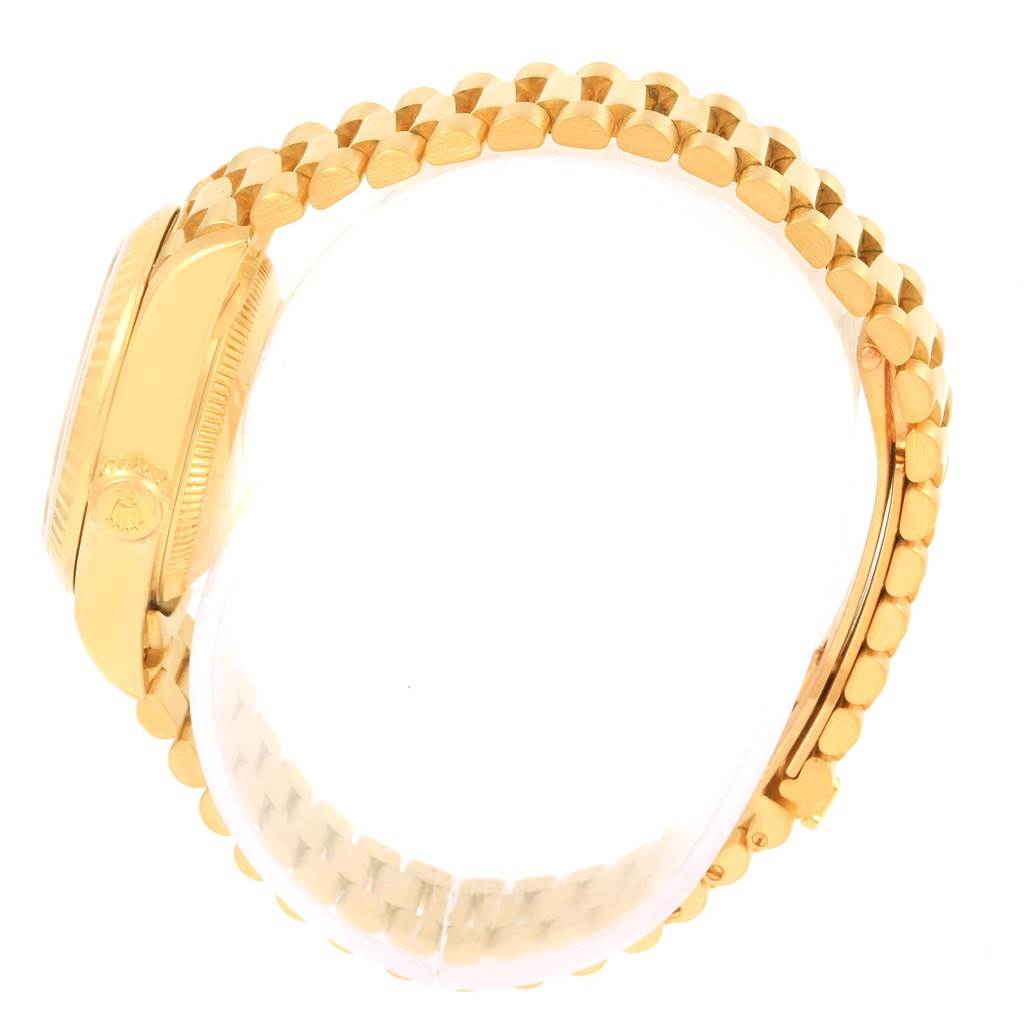 The image shows a side angle of the Rolex President 79258 Women's Yellow Gold White Dial 79258 Women's Yellow Gold White Dial model watch, highlighting its crown and gold bracelet.