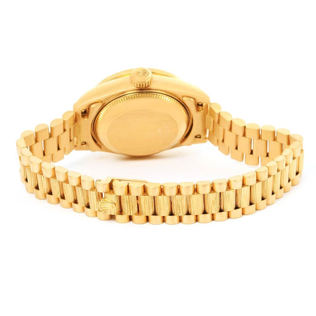 The image shows the backside and bracelet of a Rolex President 69288 Women's Yellow Gold Silver Dial 69288 Women's Yellow Gold Silver Dial model watch, highlighting the gold case back and links.