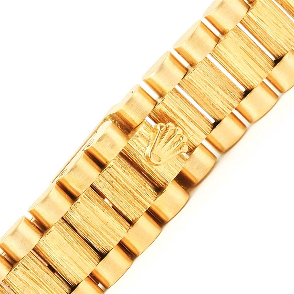 The image shows the President model Rolex watch bracelet with the iconic logo on the clasp.