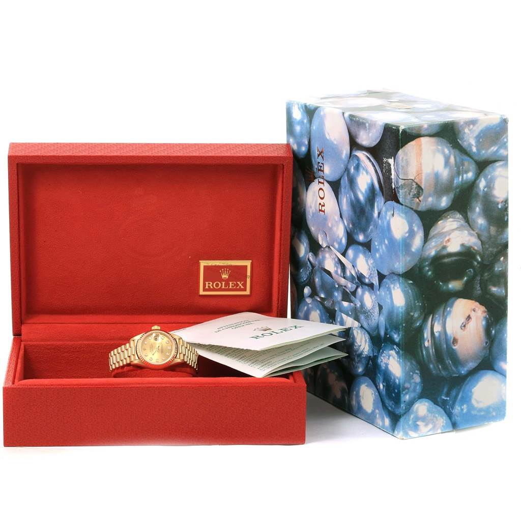 The image shows a Rolex President 79178 Women's Yellow Gold Champagne Dial 79178 Women's Yellow Gold Champagne Dial model watch in an open red box with accompanying documentation and a decorative outer box.