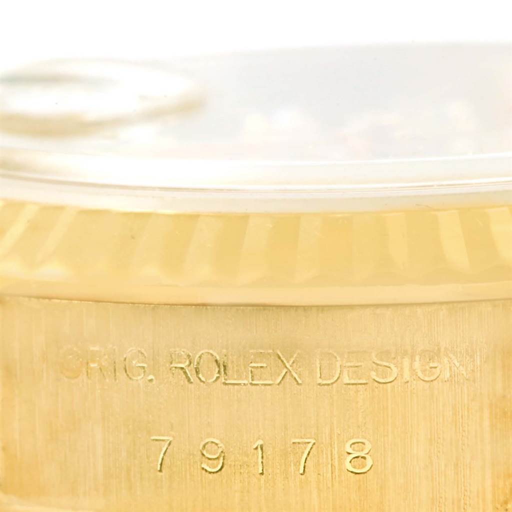 This image shows a close-up view of the side of a Rolex President 79178 Women's Yellow Gold Champagne Dial 79178 Women's Yellow Gold Champagne Dial watch case, displaying its model number and "Orig. Rolex Design" engraving.