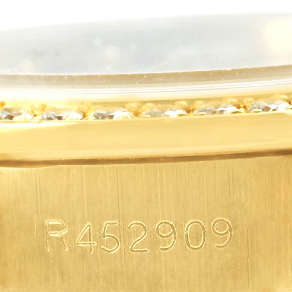 This image shows a close-up of the serial number and part of the bezel of a Rolex President 69178 Women's Yellow Gold Champagne Dial 69178 Women's Yellow Gold Champagne Dial model watch.