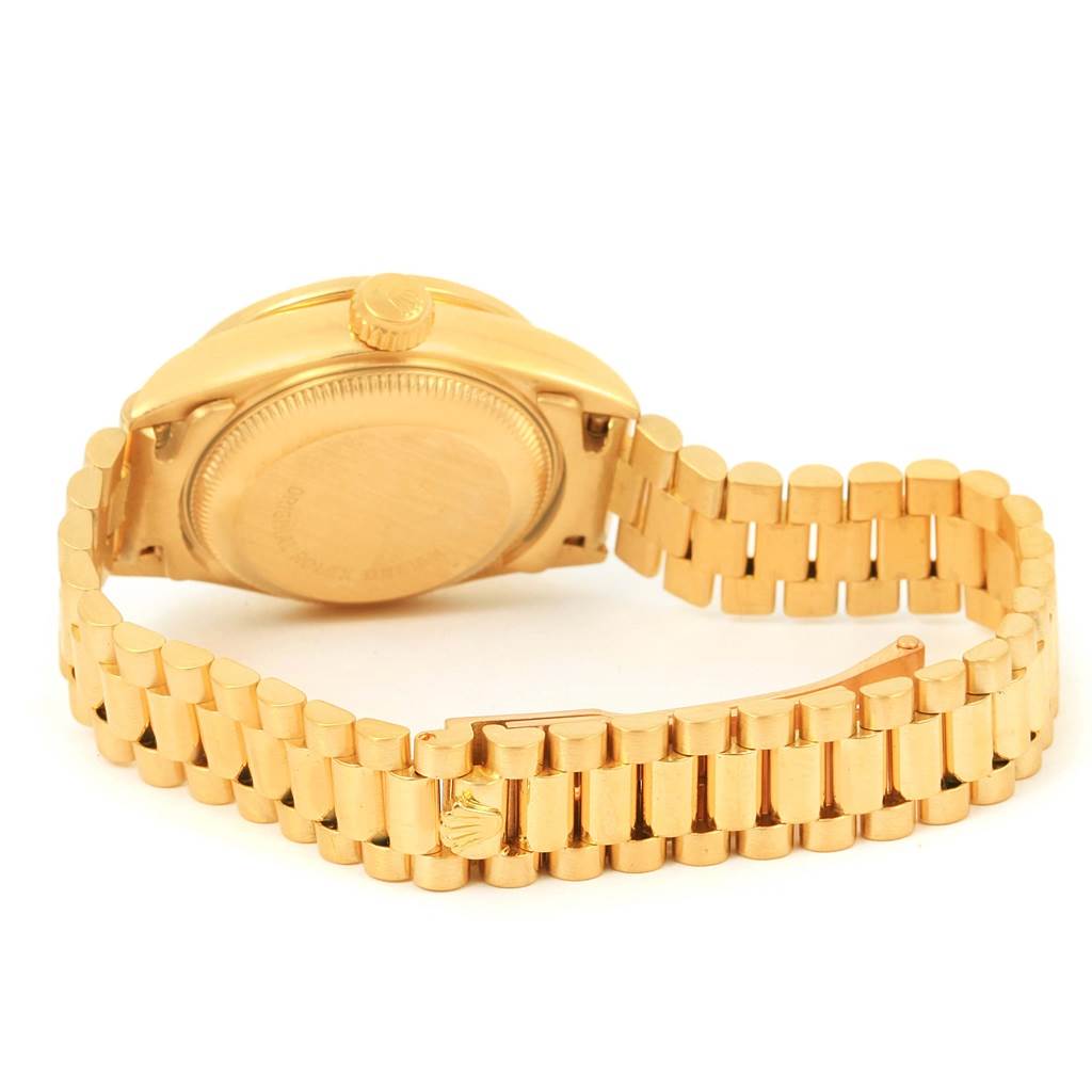The image shows the back and bracelet of the gold Rolex President 69178 Women's Yellow Gold Champagne Dial 69178 Women's Yellow Gold Champagne Dial model watch, viewed at an angle.