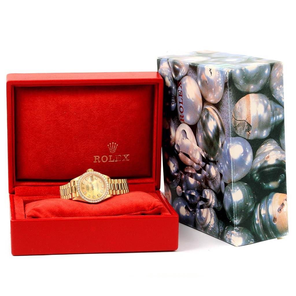 The Rolex President 69178 Women's Yellow Gold Champagne Dial 69178 Women's Yellow Gold Champagne Dial model is shown front-facing in a red box with a patterned outer box beside it.