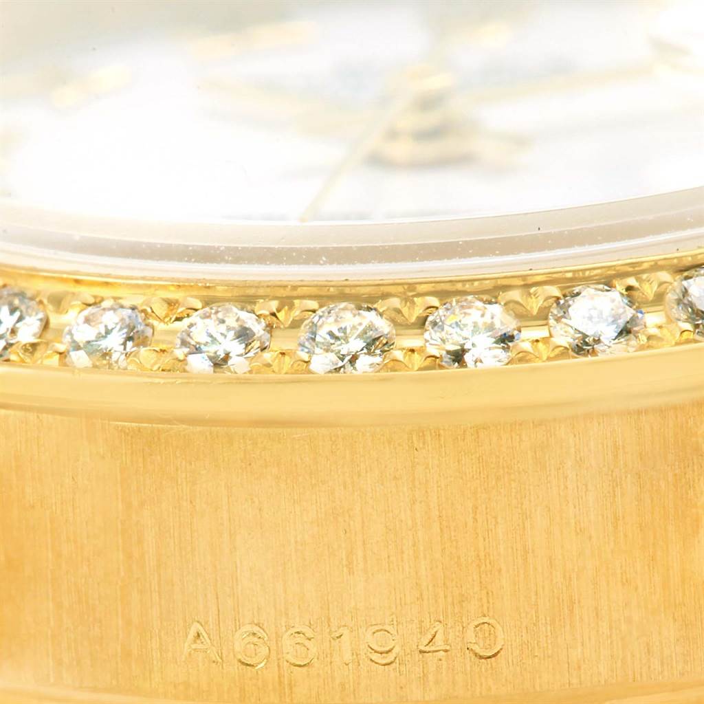 This close-up image shows the diamond-studded bezel and part of the case with the serial number of the Rolex President 79268 Women's Yellow Gold White Dial 79268 Women's Yellow Gold White Dial model watch.