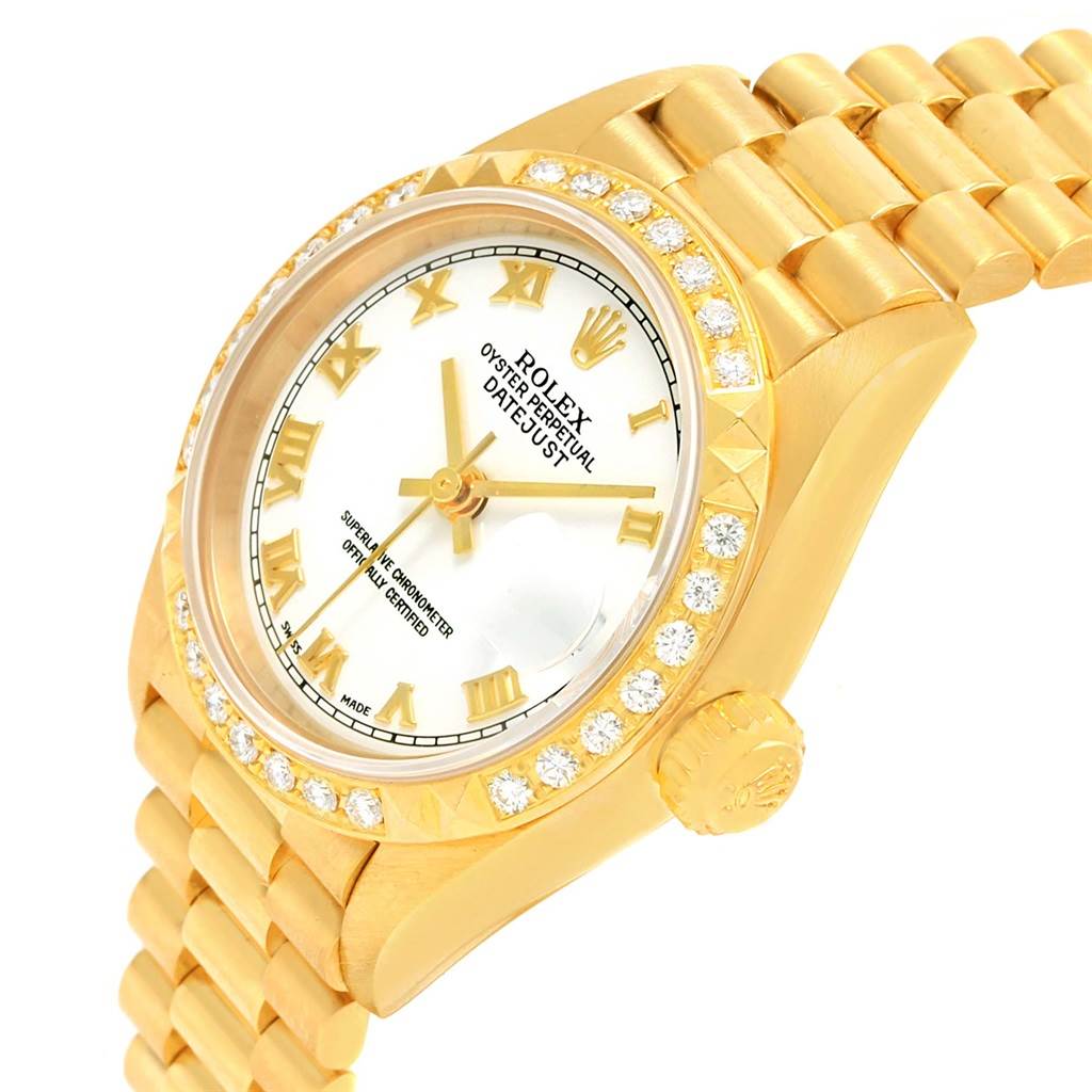 The Rolex President 79268 Women's Yellow Gold White Dial 79268 Women's Yellow Gold White Dial model watch is shown from a front and side angle, highlighting its band, dial, and bejeweled bezel.
